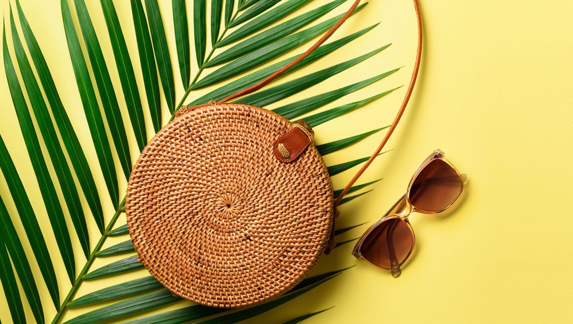 Stylish rattan bag on table